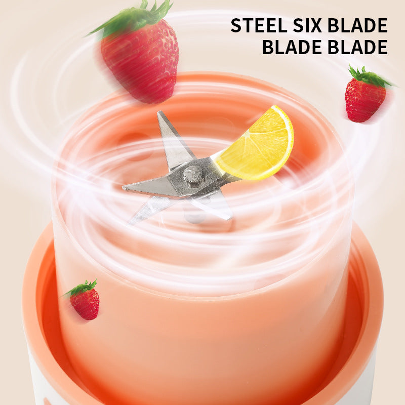 Electric juicer with a steel six blade and strawberry and lemon decorations on a beige background