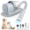 Gray dog grooming vacuum with hose and grooming attachments, shown with a dog and a cat