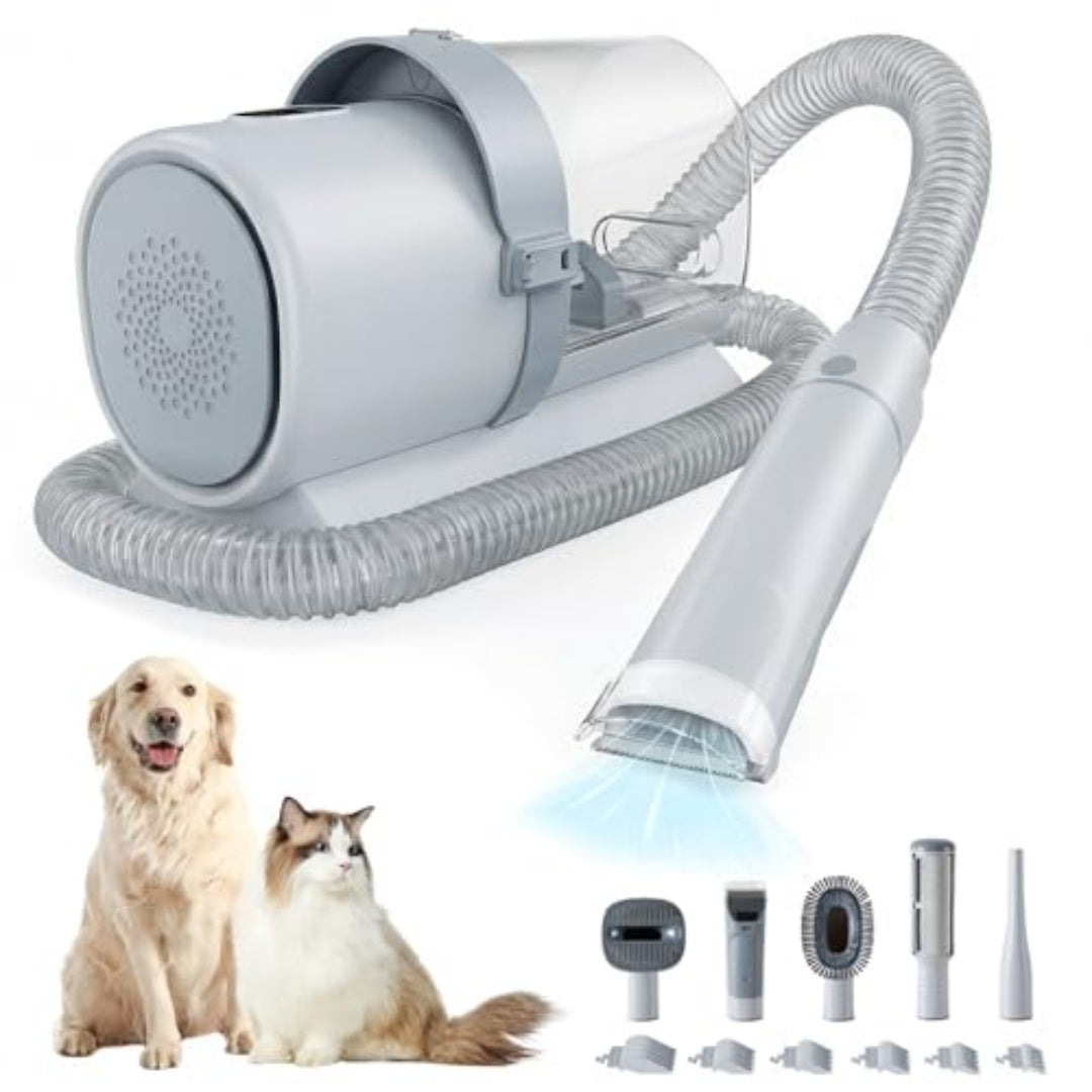 Gray dog grooming vacuum with hose and grooming attachments, shown with a dog and a cat