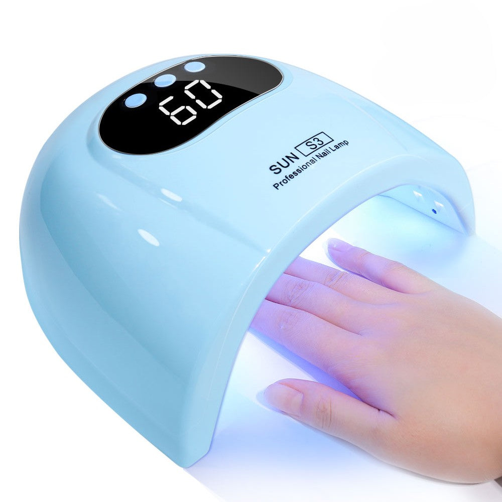 A light blue professional UV nail lamp with a digital LED display showing 60, with a hand resting inside the lamp emitting a blue light.