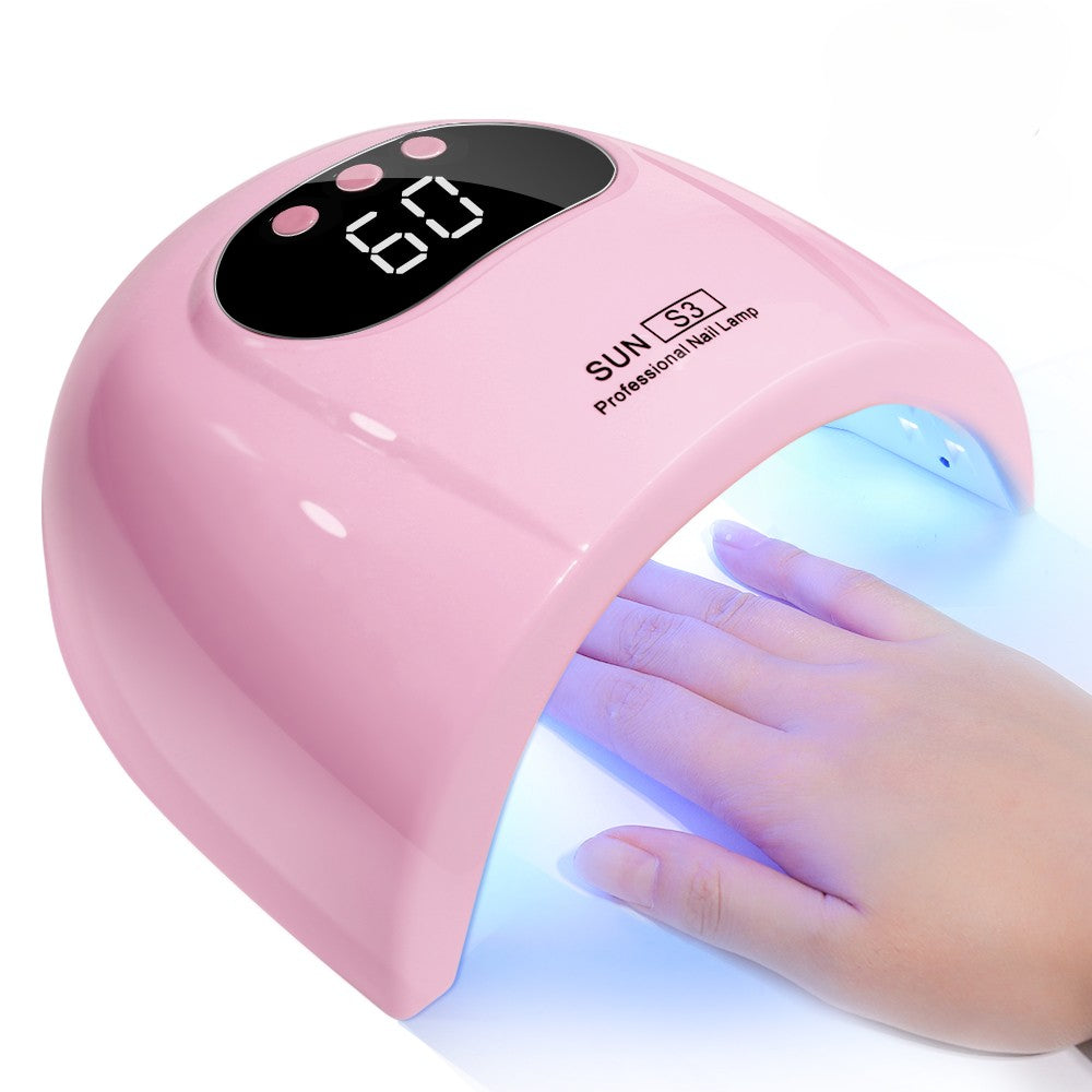 A pink UV nail lamp with a digital display showing 60 seconds and a hand resting inside the illuminated lamp, on a white background.