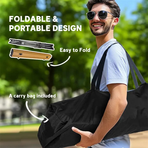 Man carrying the folded camping table in its black carry bag