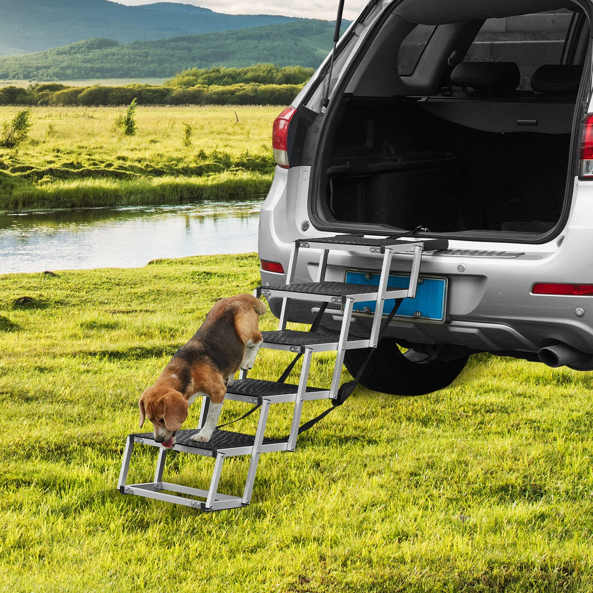 Beagle walking up folding dog stairs into an SUV parked by a lake
