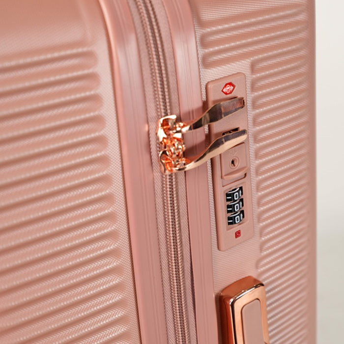 Close-up of the combination lock and zipper on a rose gold suitcase