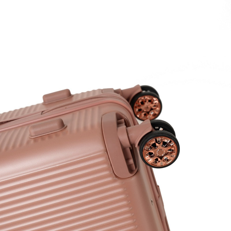 Close-up of the double 360 degree spinner wheels on a rose gold suitcase